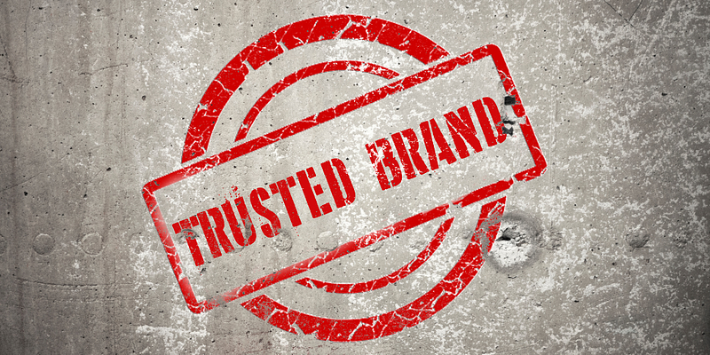 Trusted Brand stamped onto a concrete wall